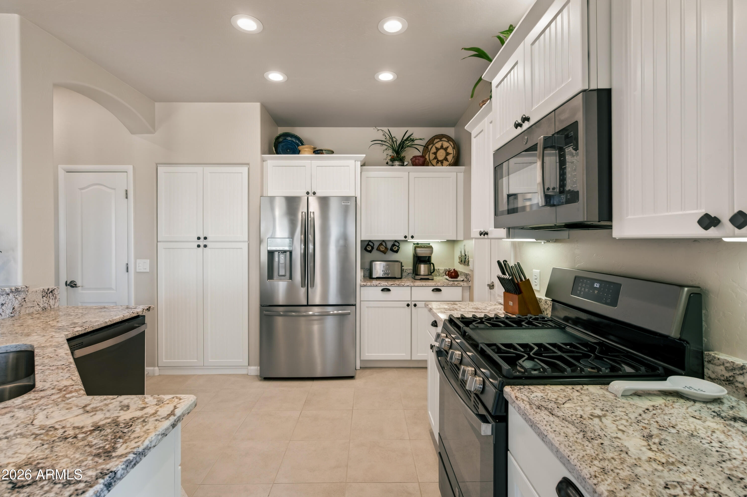 718 South Wandering River Road Cornville, AZ 86325 - Photo 13 of 41 a kitchen with refrigerator stove and microwave