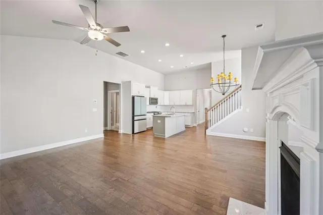 a kitchen with granite countertop white cabinets and a sink