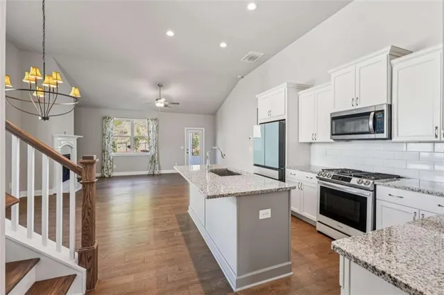 a view of a kitchen with wooden floor and a window