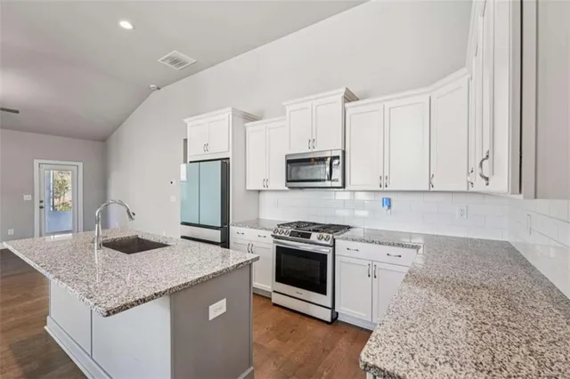a kitchen with cabinets and window