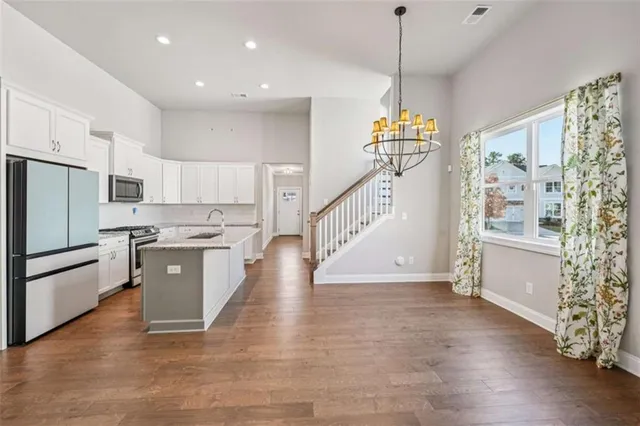 a spacious bathroom with a double vanity sink a mirror and a shower
