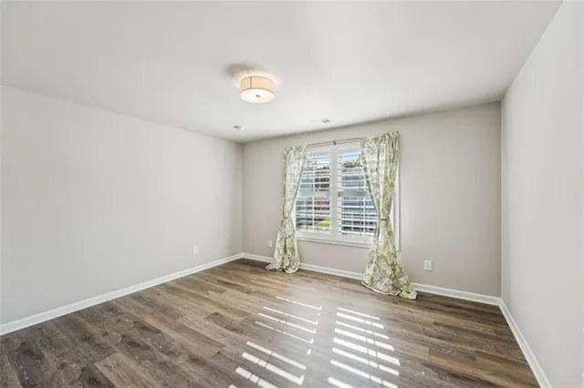 a view of a tennis court with lamp on both side of it