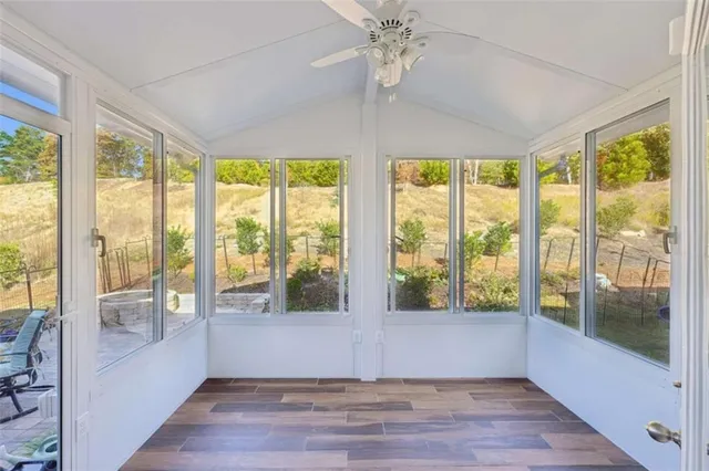 a view of a swimming pool with a bench and trees around