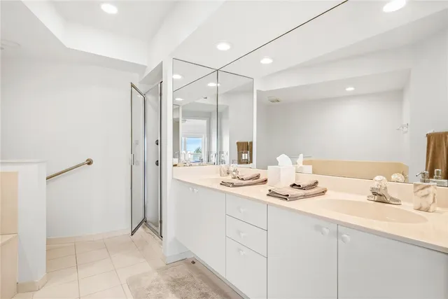 a bathroom with a sink double vanity and a mirror