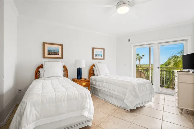 a spacious bedroom with two beds and a large window