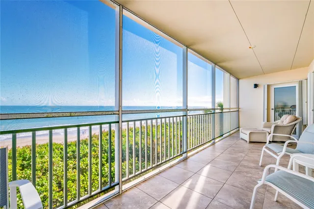 a view of a balcony with furniture