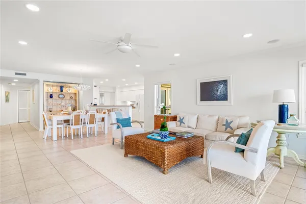 a living room with furniture and a view of kitchen