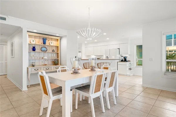 a dining room with stainless steel appliances a table and chairs