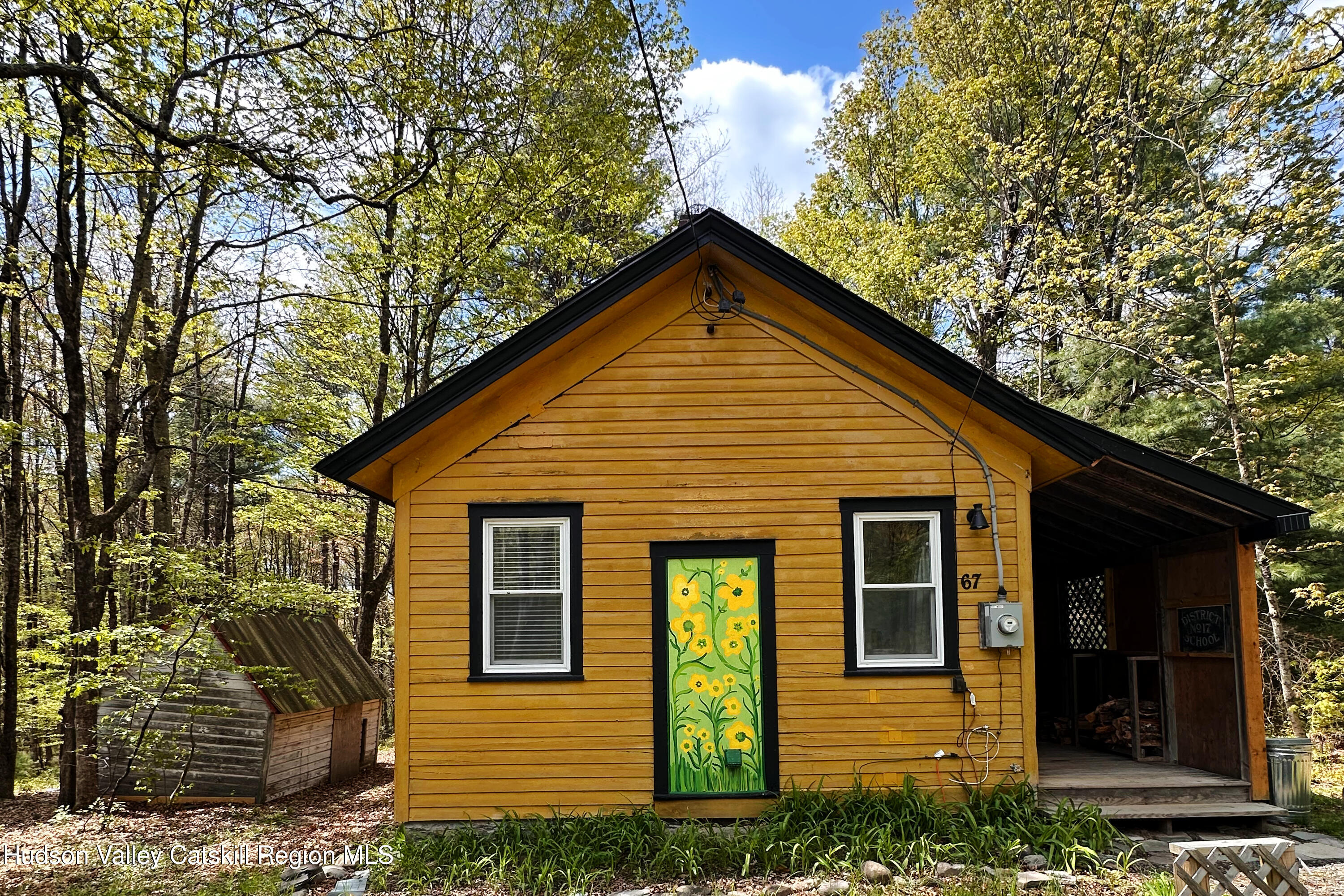 67 Katzman Road Ellenville, NY 12428 - Photo 1 of 14 a front view of a house with garden