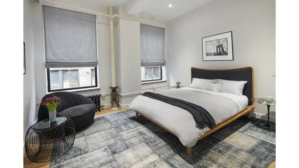 a view of walk in closet with clothes