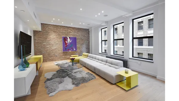 a living room with furniture and large windows