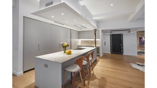 a large white kitchen with a large window
