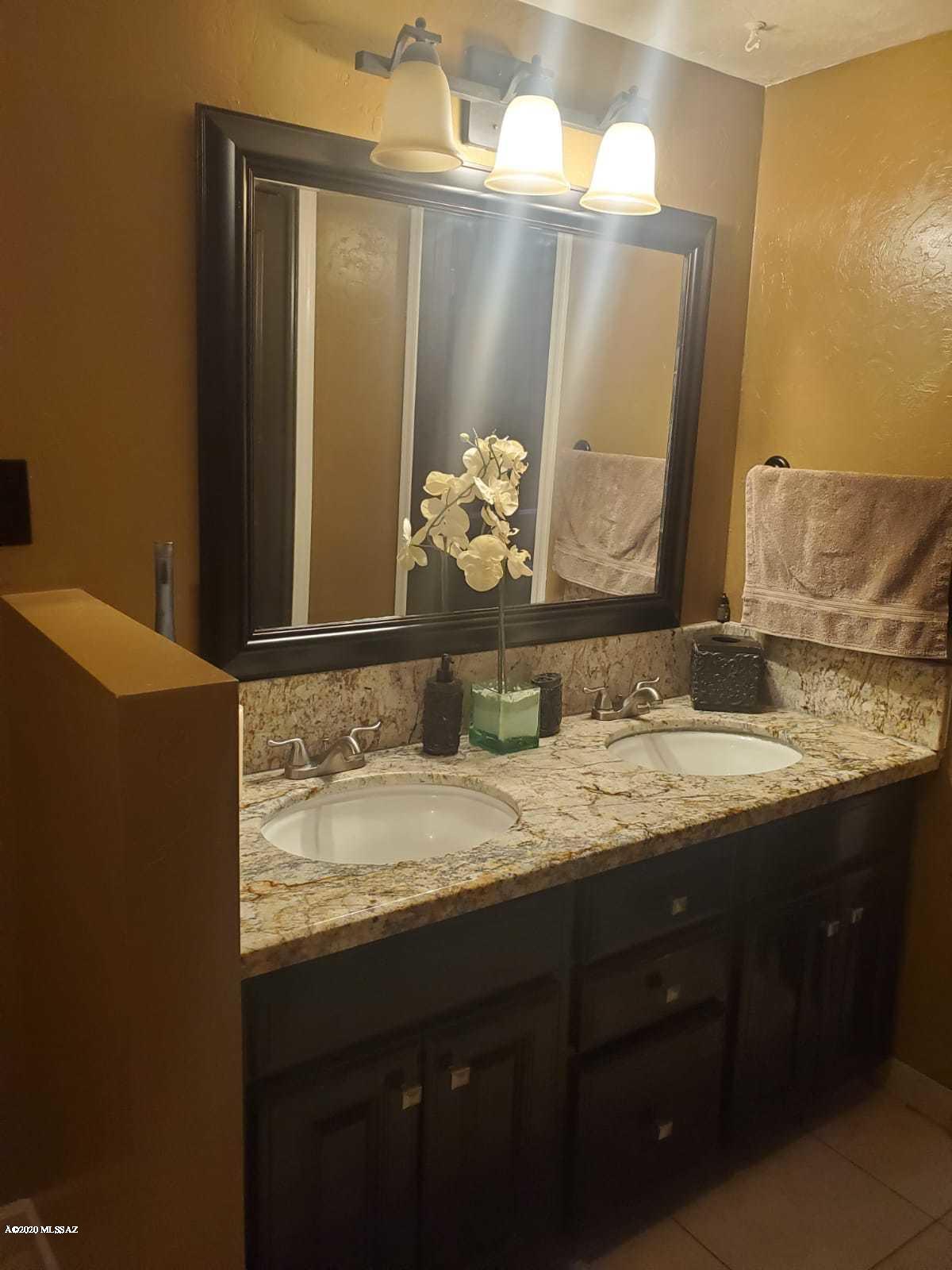 1186 Avenida Leon Rio Rico, AZ 85648 - Photo 20 of 31 a bathroom with a granite countertop sink and a mirror