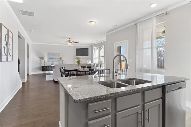 a kitchen with granite countertop a sink and cabinets