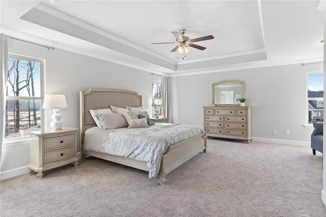 a spacious bedroom with a bed and a cabinets