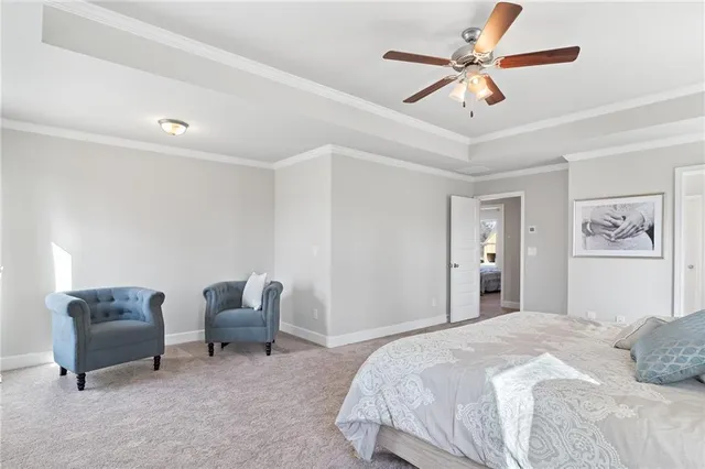 a bedroom with furniture and a ceiling fan