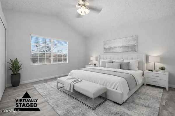 a bedroom with a large bed and a window