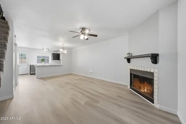 a view of an empty room with a fireplace