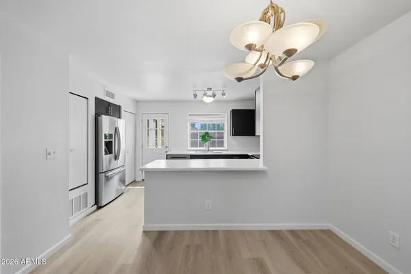 a view of a kitchen with a sink and dishwasher a wooden floor