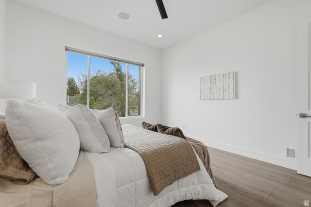 653 East Vandalay Lane Draper, UT 84020 - Photo 25 of 61 Spacious room featuring a large window, light wood-finish flooring, recessed lighting, a modern ceiling fixture, and a white paneled door