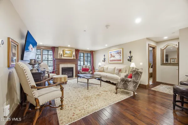 a living room with fireplace furniture and a wooden floor