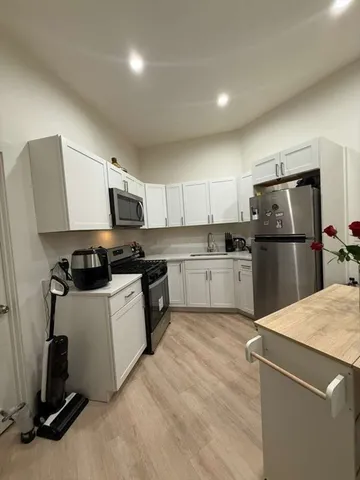 a kitchen with a refrigerator a sink and a stove