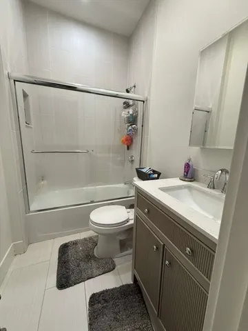 a bathroom with a toilet sink and shower