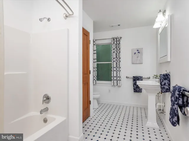 a view of a house with a yard patio and a small yard