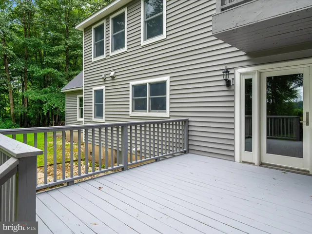 a view of a lake with a yard and trees