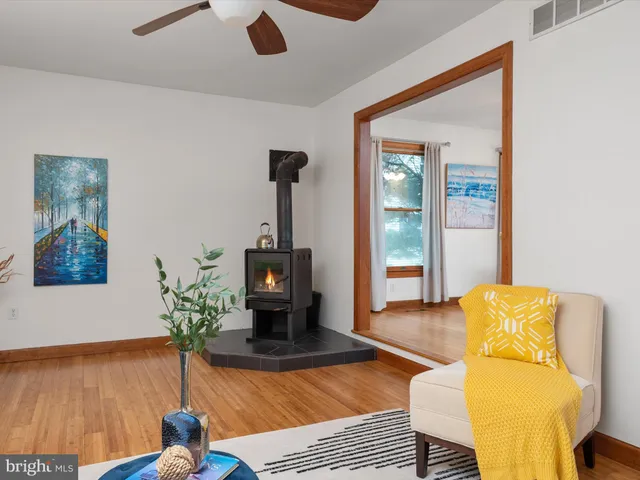 a dining room with wooden floor a chandelier a glass table and chairs