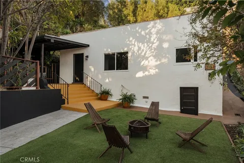 a kitchen with stainless steel appliances granite countertop a sink a stove a refrigerator and cabinets