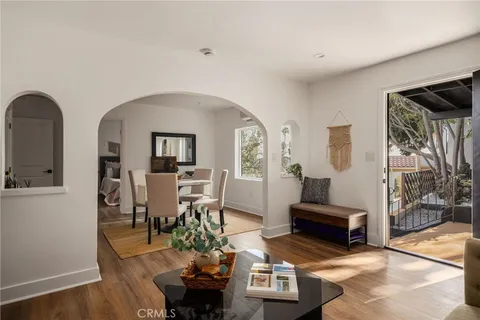 a view of a hallway with workspace and wooden floor