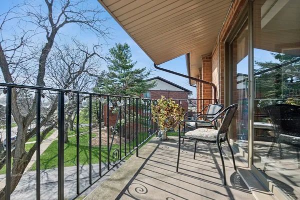 a view of balcony with wooden floor and outdoor seating