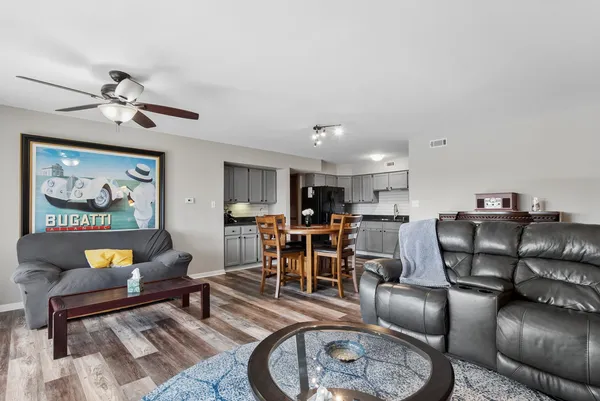 a living room with furniture a rug and a chandelier
