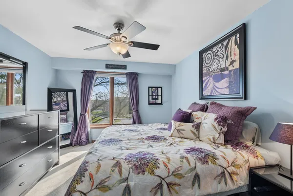 a bedroom with a large bed and a chandelier