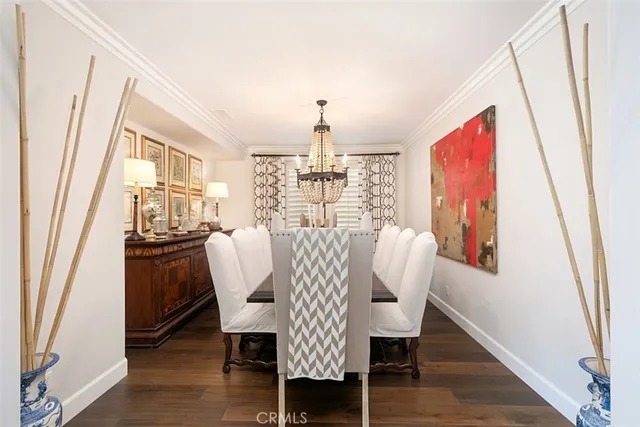 a dining room with furniture window and wooden floor