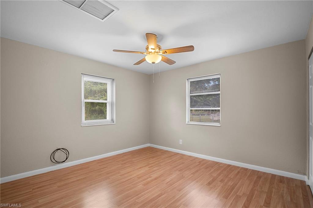 1758 Coronado Road Fort Myers, FL 33901 - Photo 8 of 12 Unfurnished room featuring light wood-style flooring and ceiling fan