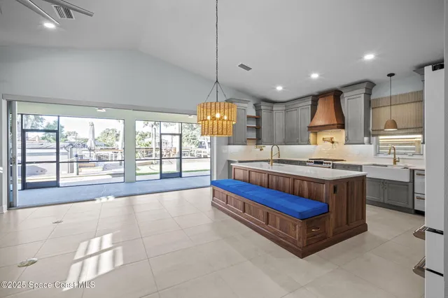 a kitchen with granite countertop a sink and a stove top oven