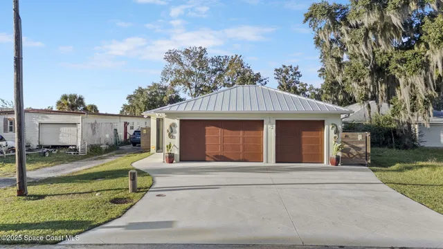 a view of a house with a yard and garage