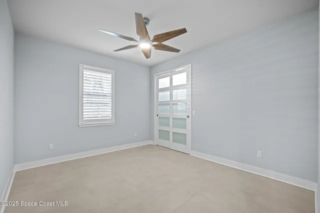 an aerial view of a house with swimming pool and large trees