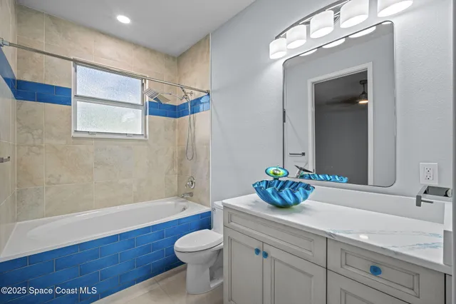 an aerial view of a house with a yard and lake view