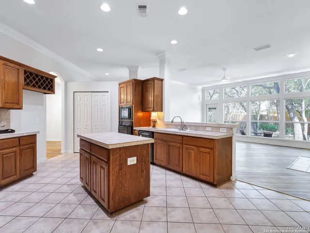 a kitchen with stainless steel appliances granite countertop a stove and a refrigerator