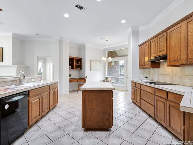 a large kitchen with stainless steel appliances lots of counter top space
