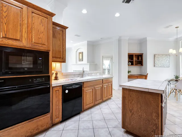 a kitchen with stainless steel appliances granite countertop a stove and a sink
