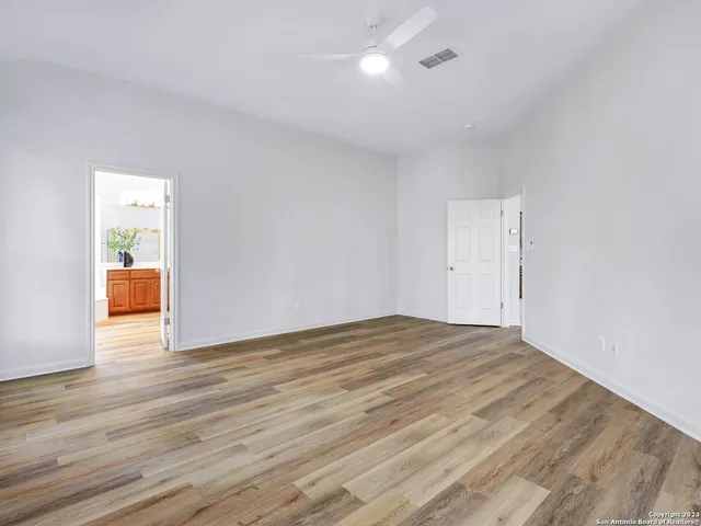 a view of an empty room and wooden floor