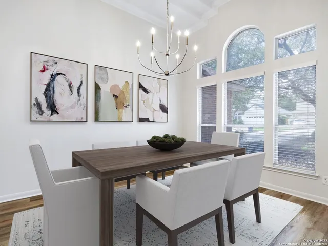 a view of a dining room with furniture large window and wooden floor