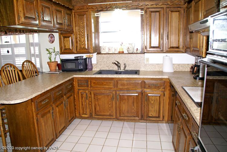201 East Plantation Road Amarillo, TX 79118 - Photo 3 of 12 a kitchen with stainless steel appliances granite countertop a sink stove and cabinets