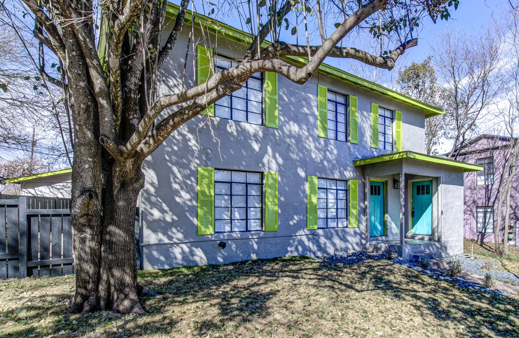 3904 Maplewood Avenue, Unit B Austin, TX 78722 - Photo 1 of 1 a view of a house with brick walls plants and large tree