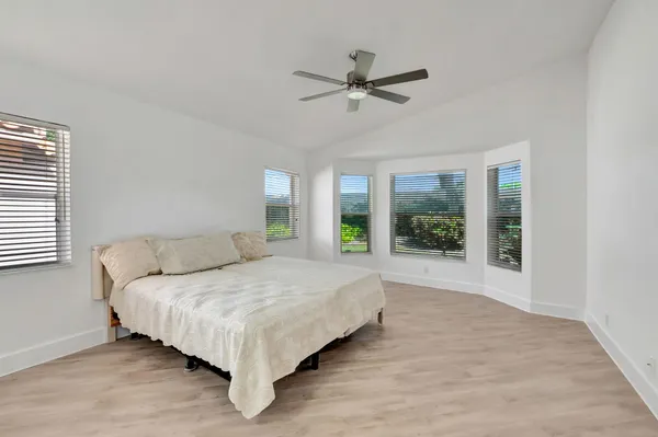 a bedroom with a large bed and a chandelier