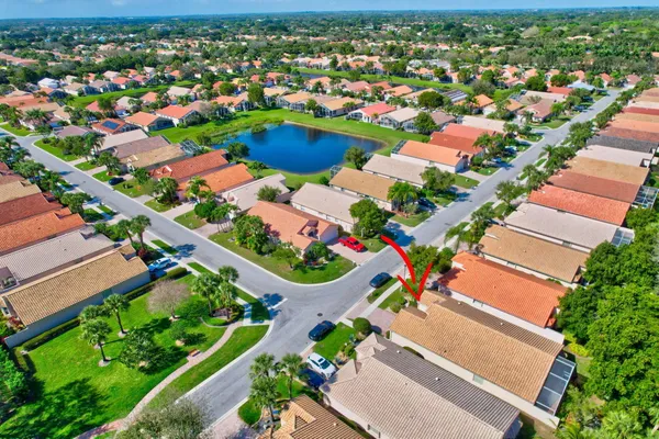 a view of swimming pool with a yard and palm trees
